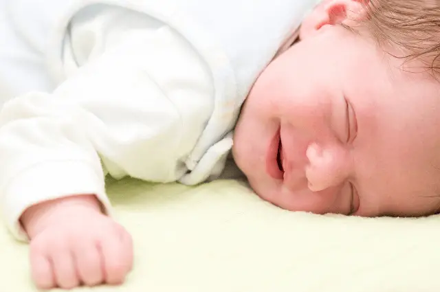 2 Weeks-old baby laughing in sleep